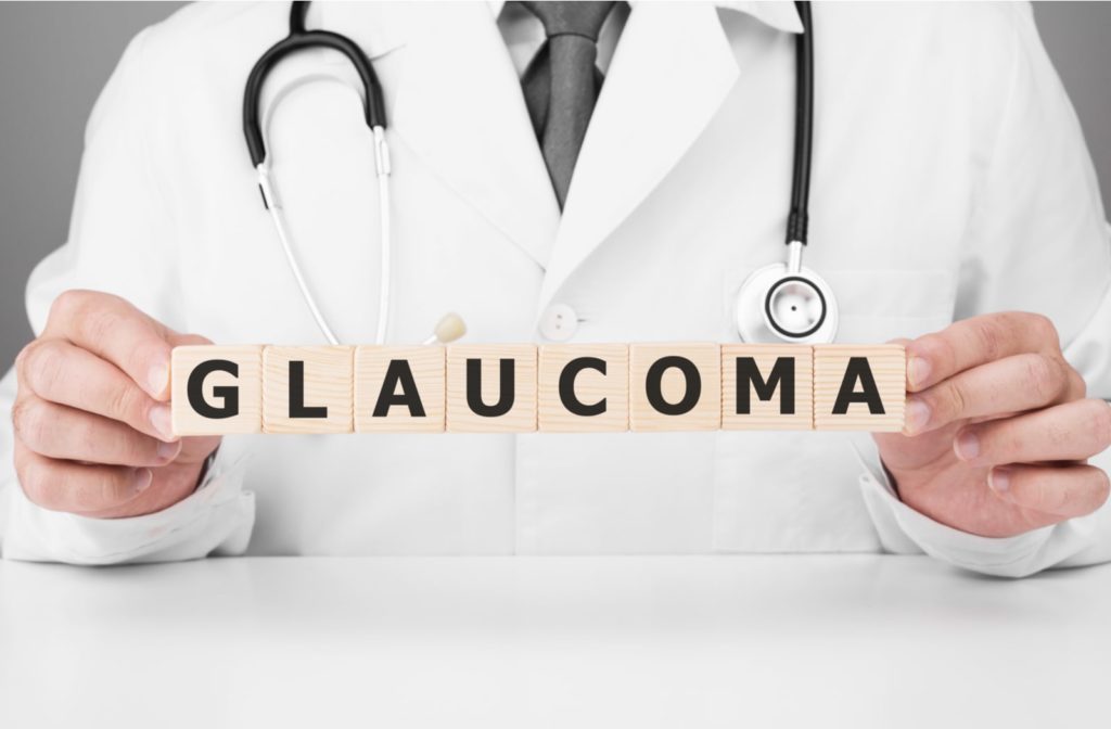 A doctor holding wooden blocks that spell "glaucoma"