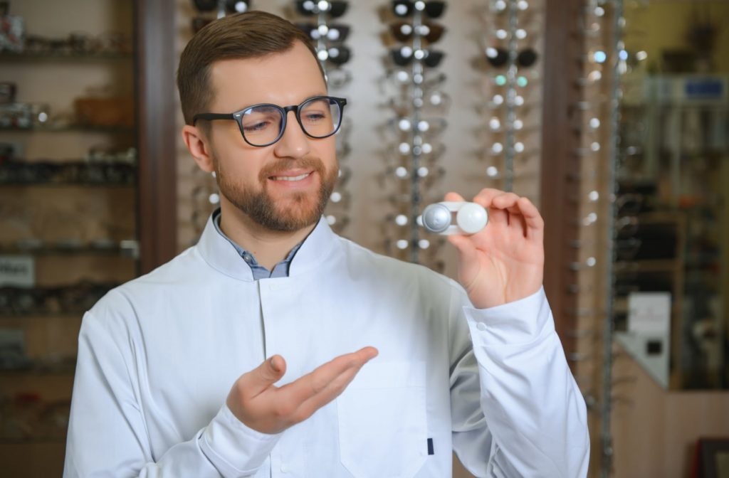 An optometrist presenting a case of contact lenses that are recommended for people with dry eyes.